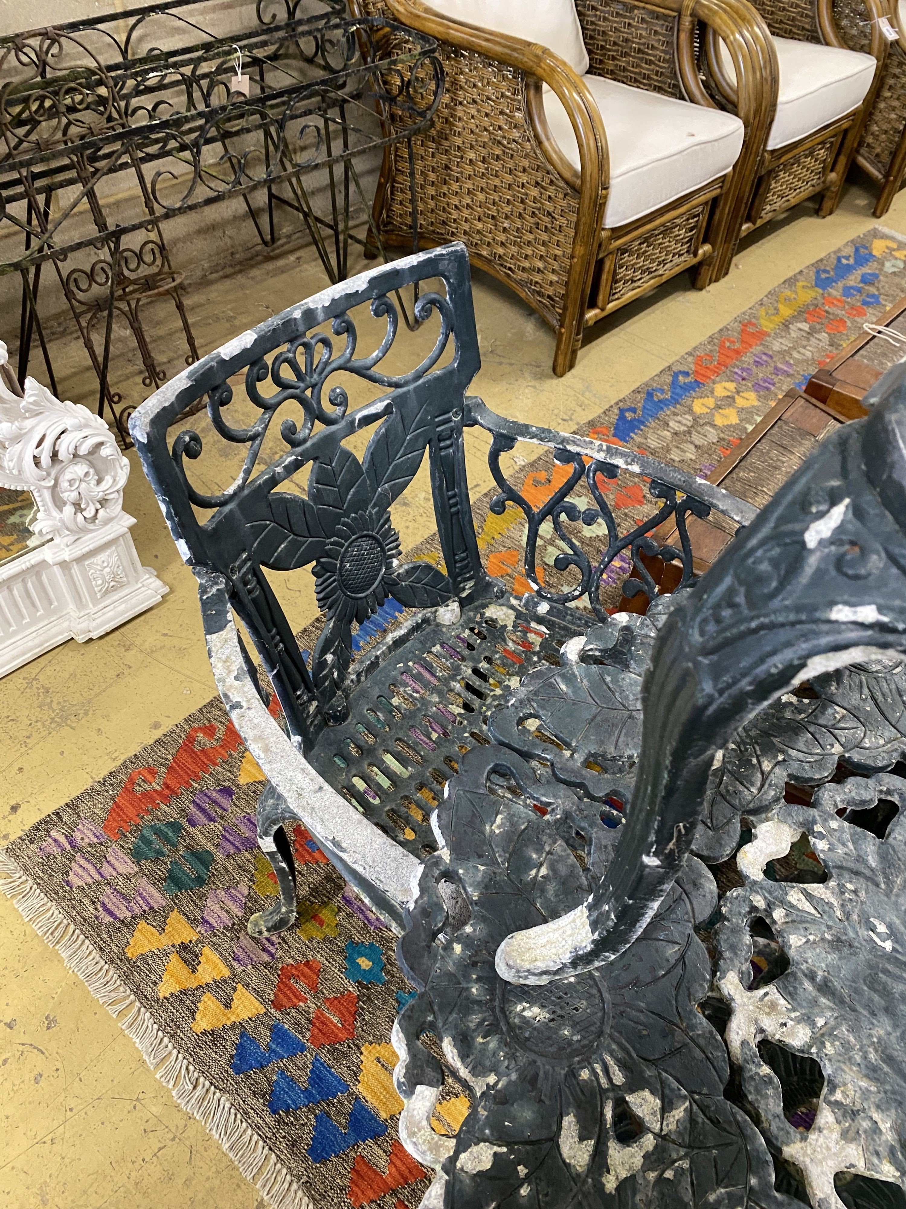 A circular painted aluminium garden table, diameter 76cm, height 70cm and three similar elbow chairs